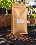 Goldsmith & Sons Signature Blend 500g whole bean coffee in a kraft bag with roasted coffee beans.